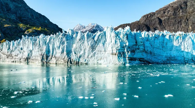 Tidewater glacier face rising from the sea in Kenai Fjords National Park, seen from a cruise boat out of Seward