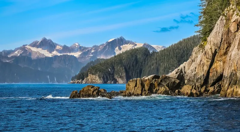 Rocky Resurrection Bay coastline in summer sun near Seward, Alaska